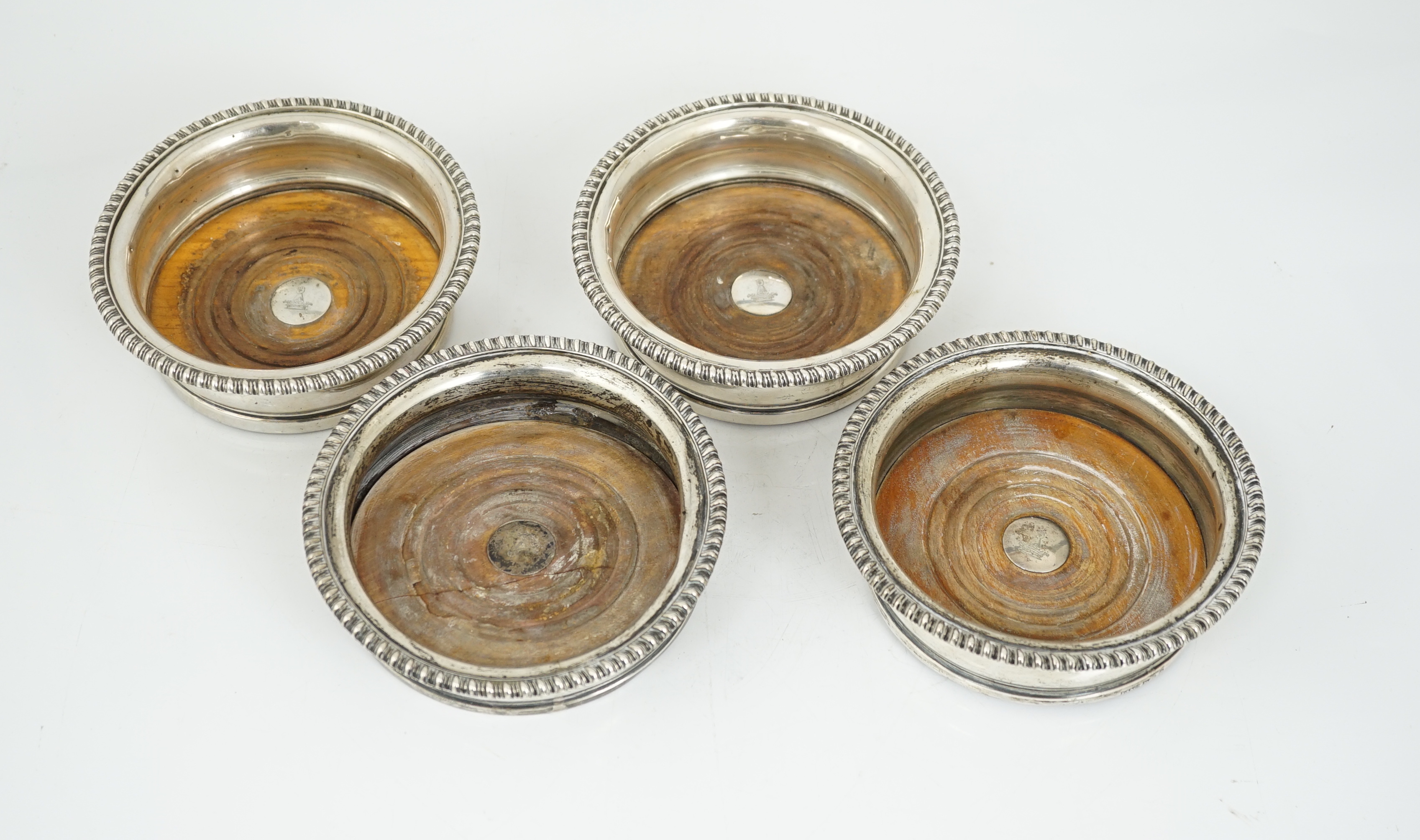 Two pairs of early 19th century silver mounted wine coasters